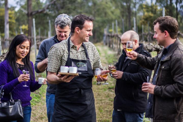 a group of people holding wine glasses